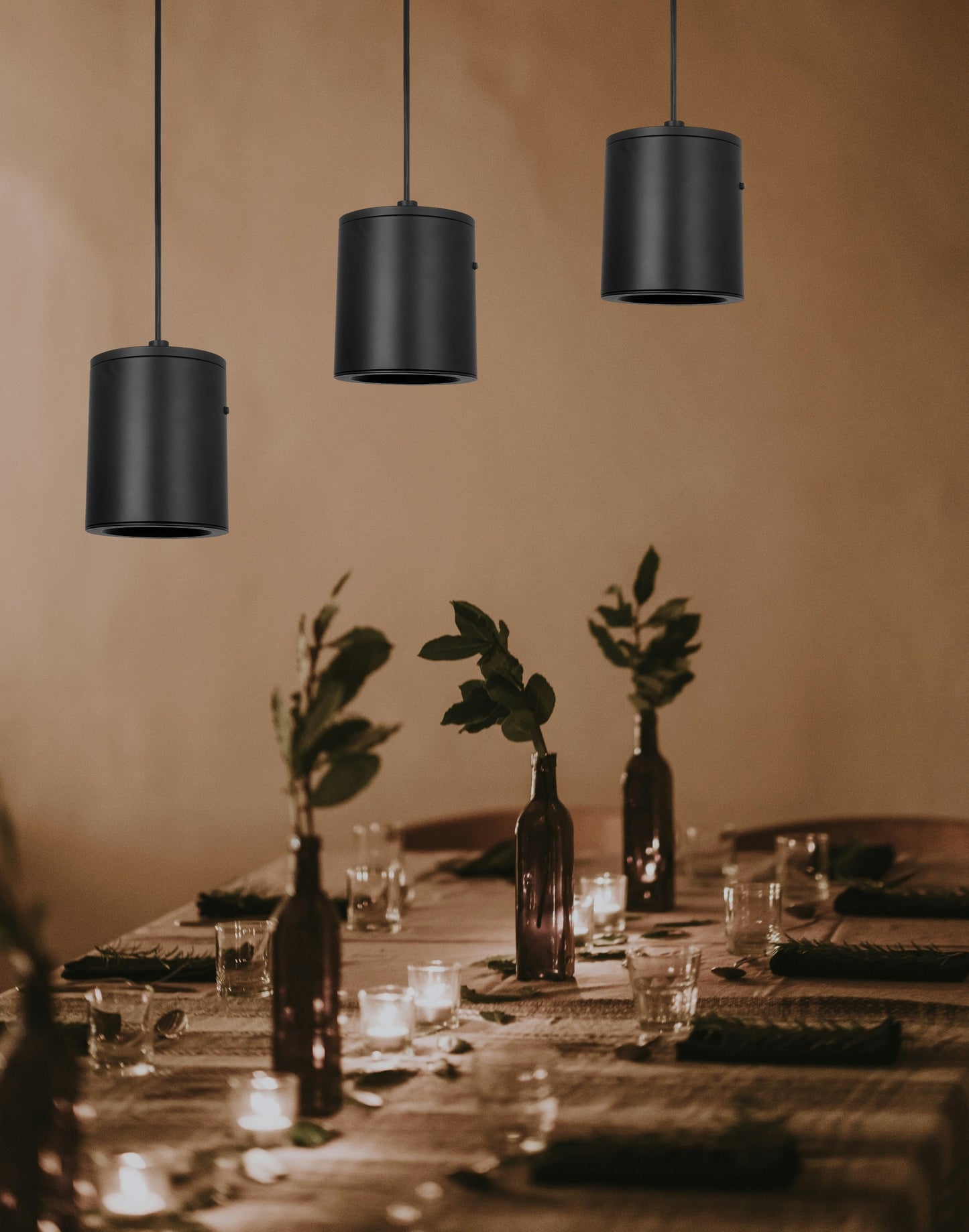 3-pack modern dimmable LED pendant cylinder lights with 3CCT adjustable hanging in a restaurant or dining area, creating a romantic atmosphere, featuring black matte finish and adjustable hanging height