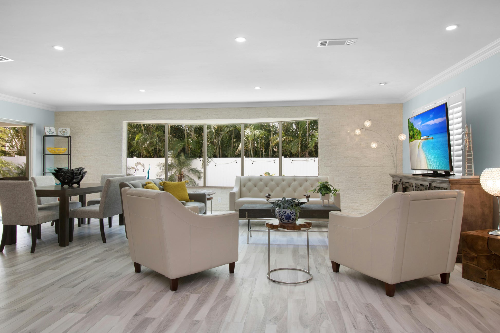 Modern living room interior illuminated with ultra slim LED recessed ceiling downlights, showcasing elegant décor, soft ambient lighting, and contemporary residential design.
