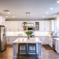 Elegant modern kitchen with white cabinetry illuminated by ultra slim LED recessed downlights providing soft, even, and energy-efficient ceiling lighting.
