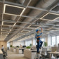 Multiple 2x2 LED frame lights installed in modern open office ceiling grid providing bright uniform commercial lighting for productive workspace environment