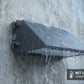 IP65 wet-location-rated LED wall pack light operating in rainy outdoor conditions for dependable exterior lighting.