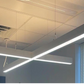 Modern LED linear pendant light installed on a ceiling