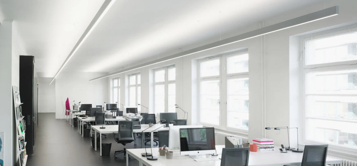 Linkable LED linear pendant lights connected together in a shared office