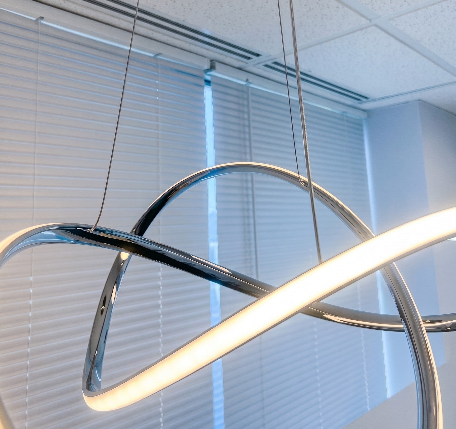 Close-up of modern LED swirl chandelier illuminated with smooth, even LED light