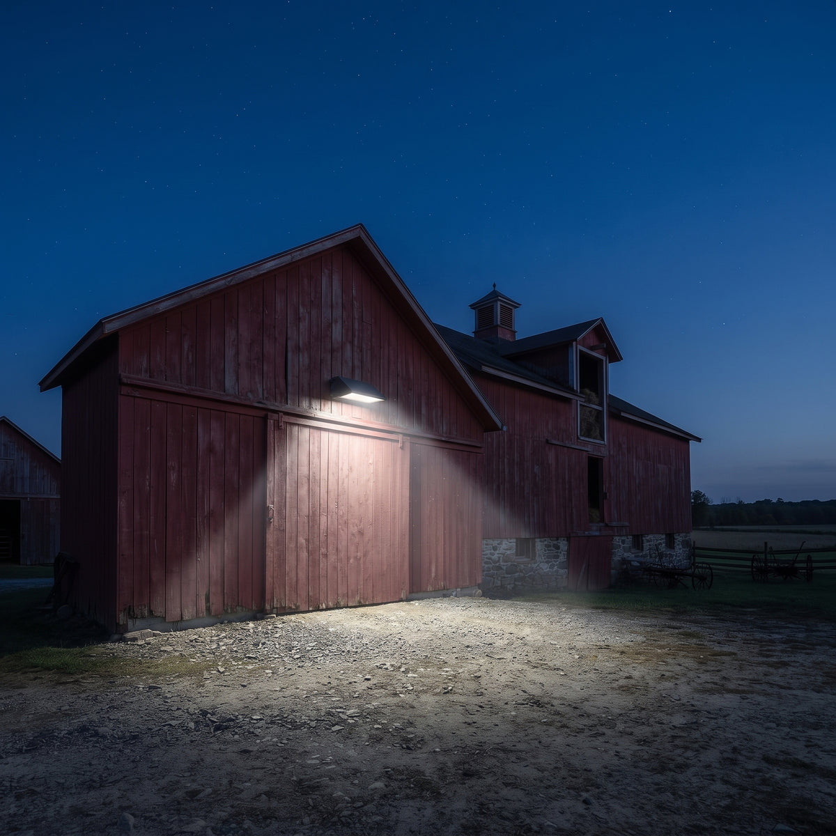 Outdoor LED wall pack lights installed on a barn exterior to illuminate the entrance and surrounding area at night.